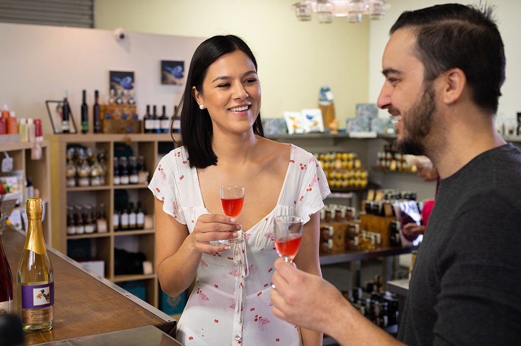 cellar-door-tastings-couple-1024x680 A young female and male couple drinking liqueur and looking at each other, smiling