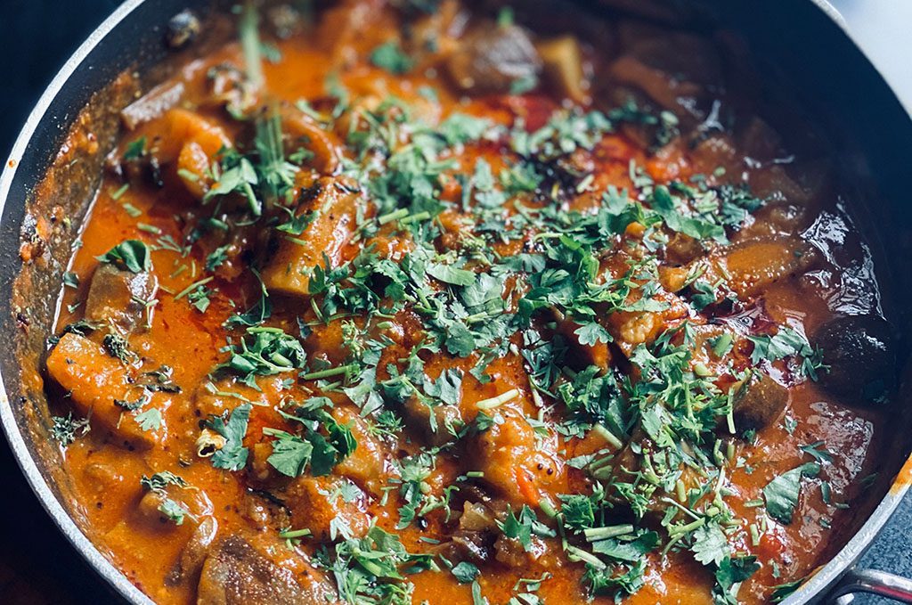 eggplant-curry-1024x680 Eggplant curry in a black pot, with coriander spinkled on top