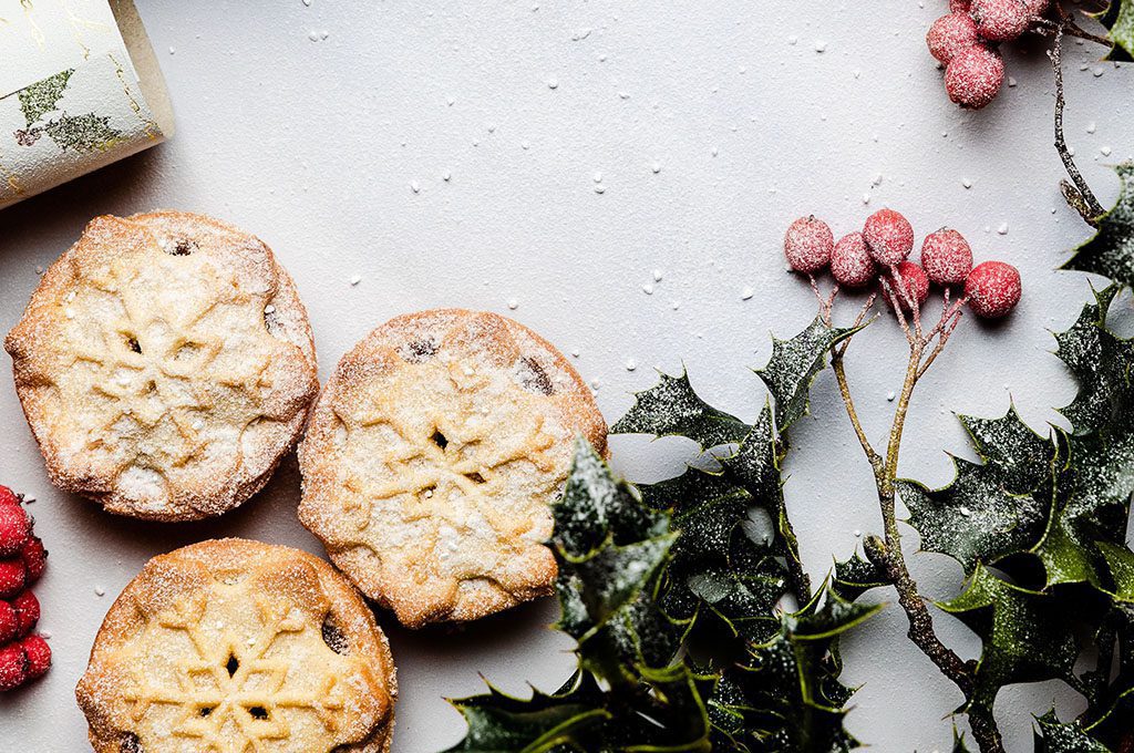 fruit-mince-pie-1024x680 Fruit mince pies on a white table with holy